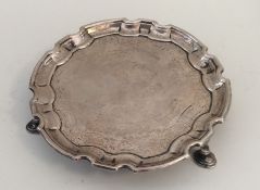 An early Georgian silver waiter with engraved deco