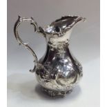 A large Victorian silver embossed cream jug with s