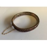 An Antique three row garnet bangle with concealed