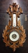 An oak carved barometer. Est. £15 - £20.