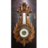 An oak carved barometer. Est. £15 - £20.