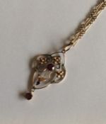 A heavy 9 carat garnet pendant on fine link chain.