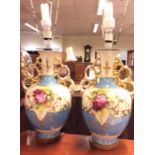 A pair of large baluster shaped vases decorated wi