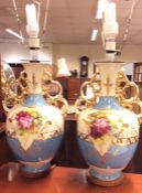 A pair of large baluster shaped vases decorated wi