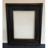 A massive hardwood picture frame. Est. £25 - £35.