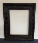 A massive hardwood picture frame. Est. £25 - £35.