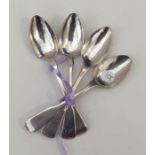 A group of four fiddle pattern silver teaspoons. A