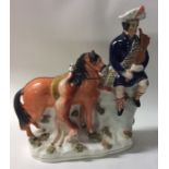 A tall Staffordshire figure of a Scotsman on horse