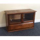 An oak two door small display unit. Est. £30 - £50