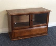 An oak two door small display unit. Est. £30 - £50