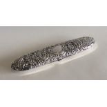 A canoe shaped embossed silver box decorated with