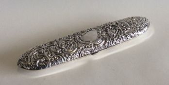 A canoe shaped embossed silver box decorated with