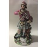 A tall Staffordshire figure of a Scotsman in Highl