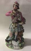 A tall Staffordshire figure of a Scotsman in Highl
