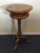 A Victorian burr walnut sewing table on twisted st