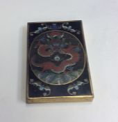 A heavy brass and cloisonné paperweight decorated