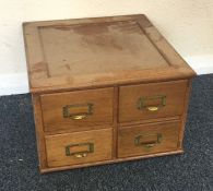 A small oak four drawer filing chest. Est. £25 - £