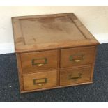 A small oak four drawer filing chest. Est. £25 - £