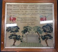 A large maple framed sampler decorated in bright f