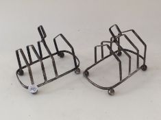 A pair of silver toast racks on ball feet. Approx.