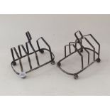 A pair of silver toast racks on ball feet. Approx.