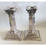 A good pair of Corinthian column silver candlestic