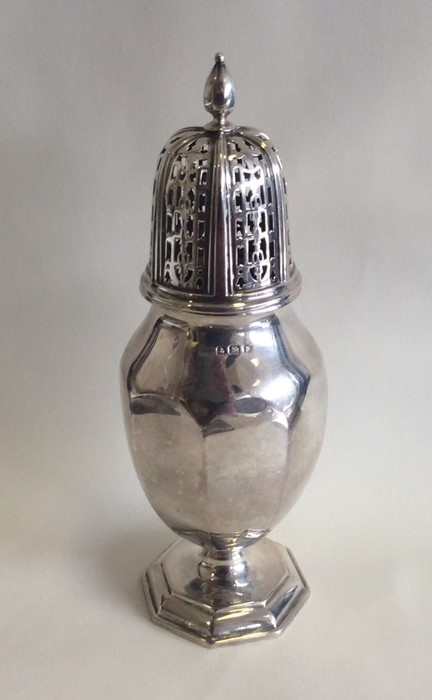 A stylish silver sugar caster with pierced cover.
