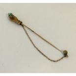 An unusual emerald and diamond stick pin in the fo