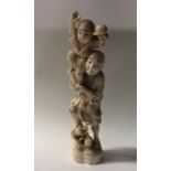 A carved ivory figure of a man with child. Approx.