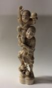 A carved ivory figure of a man with child. Approx.