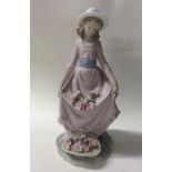 A Lladro figure of a girl curtsying. Est. £20 - £3