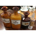 A group of three amber glass medicine bottles toge