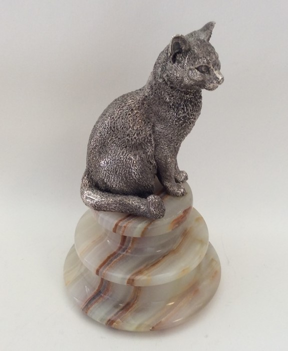 An unusual figure of a cat in seated position with