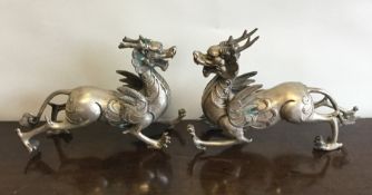 A pair of Chinese white metal figures with scroll