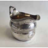 A good Georgian silver cream jug with bright cut d