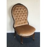 A Victorian button back mahogany nursing chair. Es