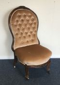 A Victorian button back mahogany nursing chair. Es