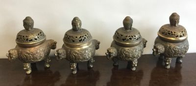 A set of four heavy Chinese brass censuses decorat