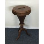 A Victorian mahogany tapering sewing table on thre