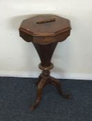 A Victorian mahogany tapering sewing table on thre