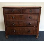 A mahogany chest of five drawers on turned support