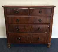 A mahogany chest of five drawers on turned support