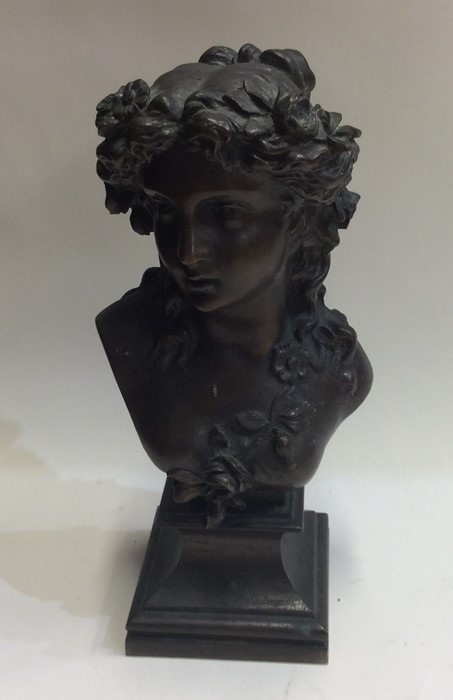 A heavy brass bust of a lady on square base. Est.