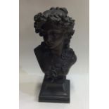 A heavy brass bust of a lady on square base. Est.