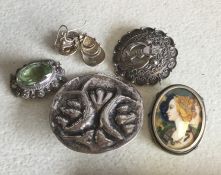 A bag containing silver and other brooches. Approx
