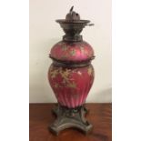 A fine quality cranberry glass lustre oil lamp on