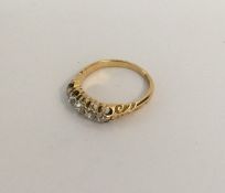 An 18 carat gold diamond five stone half hoop ring