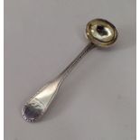A feather edged silver mustard spoon with gilt bow