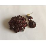 A gold mounted circular garnet brooch together wit
