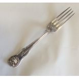 A silver dessert fork with shell decoration. Londo